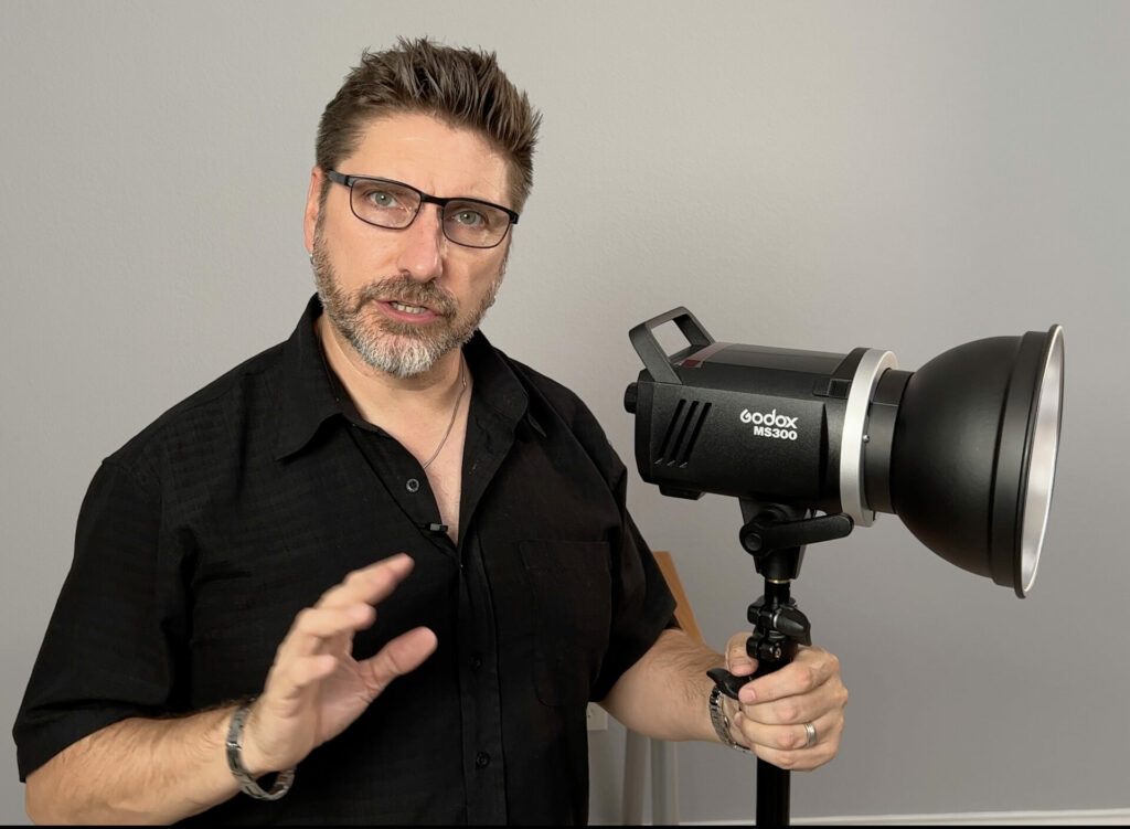 A man and the MS300 strobe with reflector.