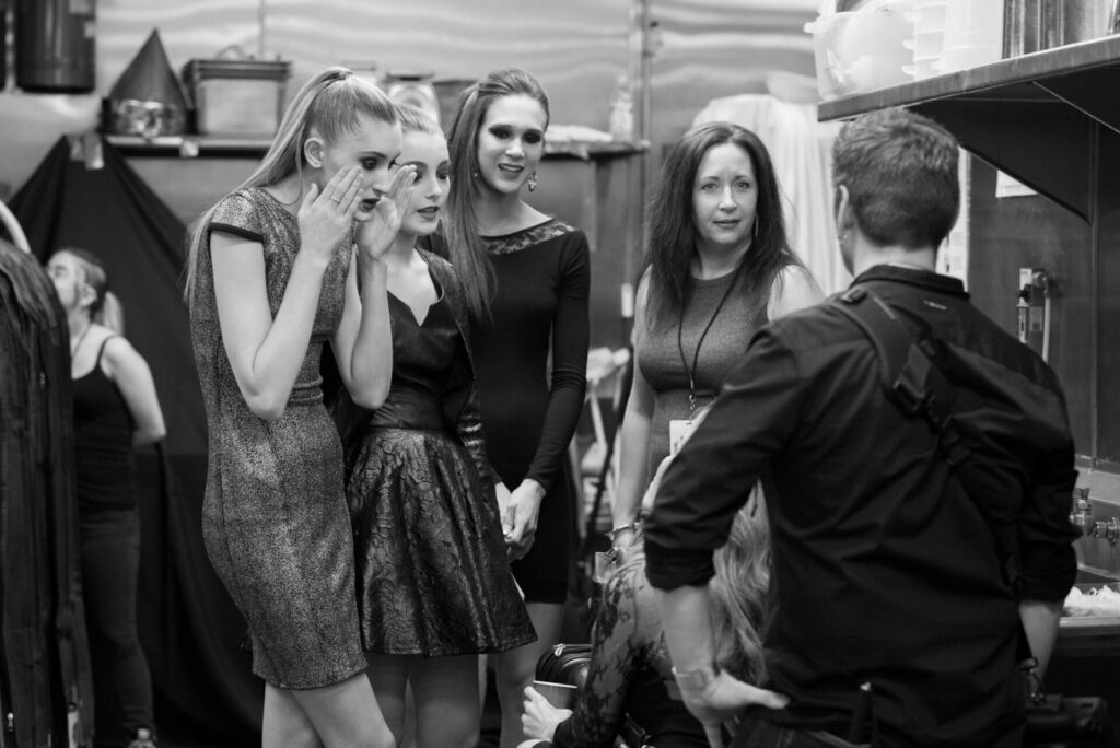 networking backstage at a fashion show
